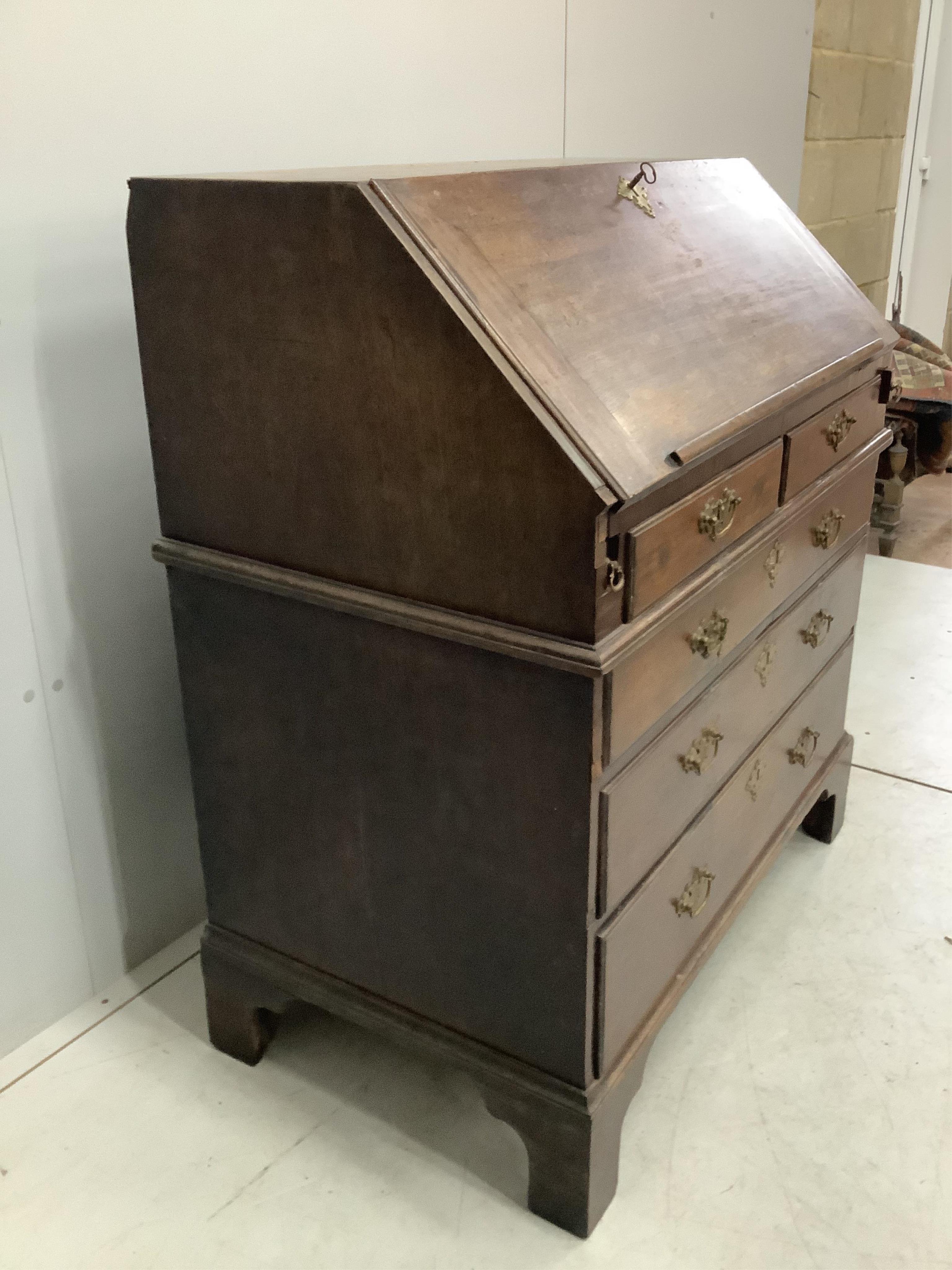 A George III mahogany bureau, width 96cm, depth 56cm, height 106cm. Condition - poor to fair, top with two areas of lost moulding